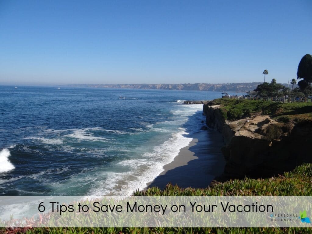 A scenic coastal view with waves crashing against rocky cliffs under a clear blue sky. Text overlay reads, "6 Tips to Save Money on Vacation." Discover breathtaking sights while you save money on vacation.