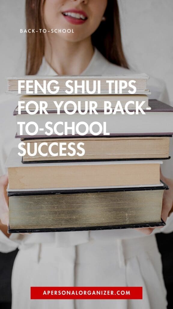 A woman in a white outfit holds a stack of books in front of her chest, symbolizing organization. Overlay text reads, "Feng Shui Tips for Your Back-to-School Success." The website apersonalorganizer.com appears at the bottom.