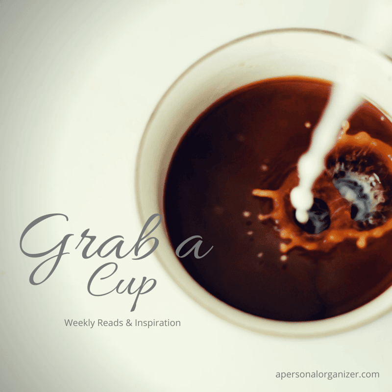 A top-view of a cup filled with coffee being splashed by a pour of cream or milk. The image reads "Grab a Cup - Weekly Reads & Organizing Inspiration" with "apersonalorganizer.com" in smaller print at the bottom right corner.
