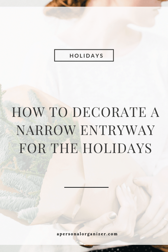 A soft-focus image of a person holding a small bundle of evergreen branches. Overlaid text reads, "HOLIDAYS. Decorating a Narrow Entryway for the Holidays." The website "apersonalorganizer.com" is displayed at the bottom.