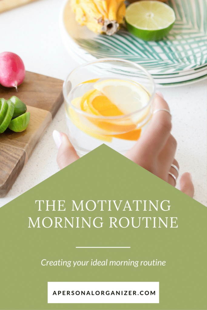 A hand holding a glass of lemon water is shown next to a cutting board with vegetables and a tropical leaf plate. The text on a green overlay reads, "The Motivating Morning Routine: Creating your ideal morning routine." The website at the bottom reads "apersonalorganizer.com.