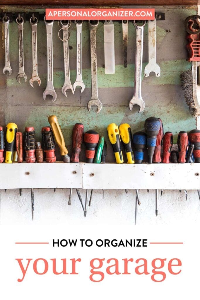 A pegboard wall with wrenches, screwdrivers, and other tools neatly organized showcases smart garage organization; text overlay reads "How to Organize Your Garage" with "apersonalorganizer.com" at the top.