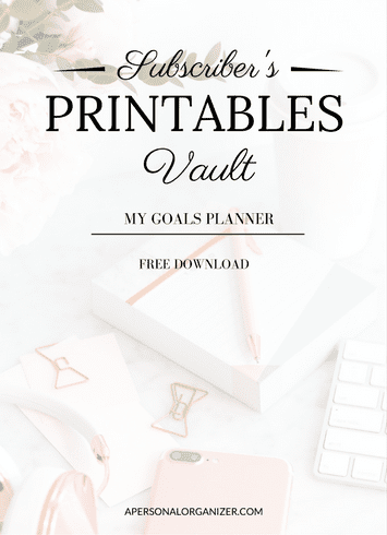 A printable planner cover with the text "Subscriber's Printables Vault - My Goals Planner - Free Download" on a desk with pink and white stationery, keyboard, and accessories—perfect for organizing your free printables at apersonalorganizer.com.
