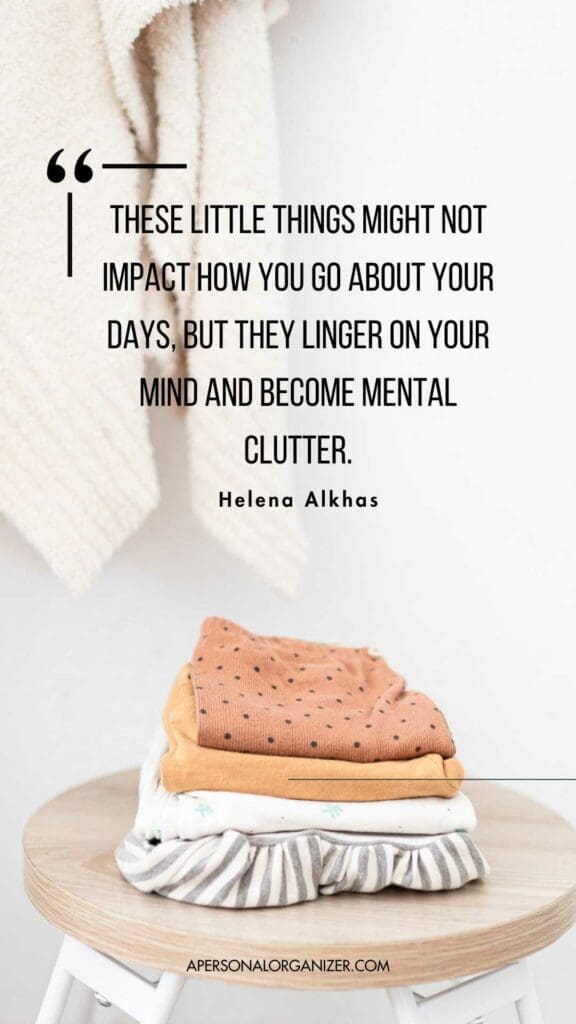 A stack of neatly folded clothes sits on a wooden stool, embodying the essence of home organizing. A beige blanket hangs in the background. Quote on the image: "These little things might not impact how you go about your days, but they linger on your mind and become mental clutter." - Helena Alkhas.