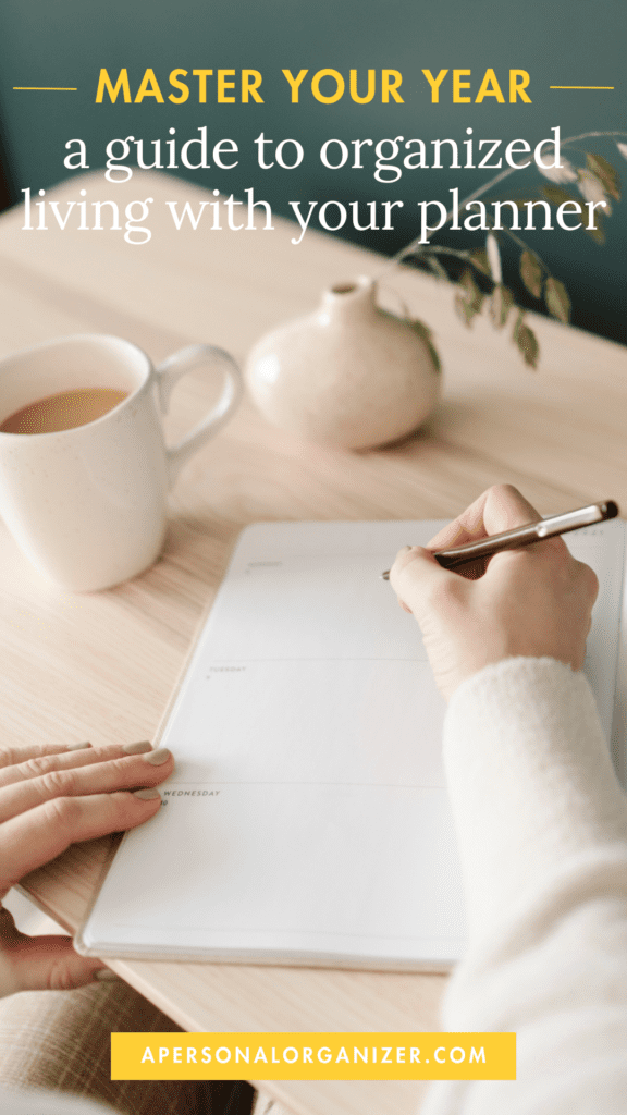 Person writing in a planner on a table with a white cup and a small vase in the background. Text reads: "Master Your Year - unleash the power of organized living with your planner." Website: apersonalorganizer.com.