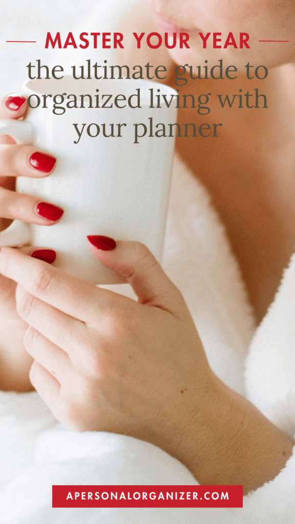 A person with red nail polish holds a white cup. Text at the top reads, "Master Your Year: the ultimate guide to organized living with your planner." A red banner at the bottom proudly displays "apersonalorganizer.com," highlighting how a well-crafted planner can transform your life.
