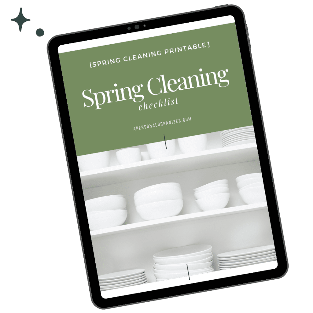 A sleek tablet showcases a green and white digital "Spring Cleaning Checklist," perfectly complemented by a photo of neatly arranged white dishware, adding a touch of home decor elegance to open shelves.
