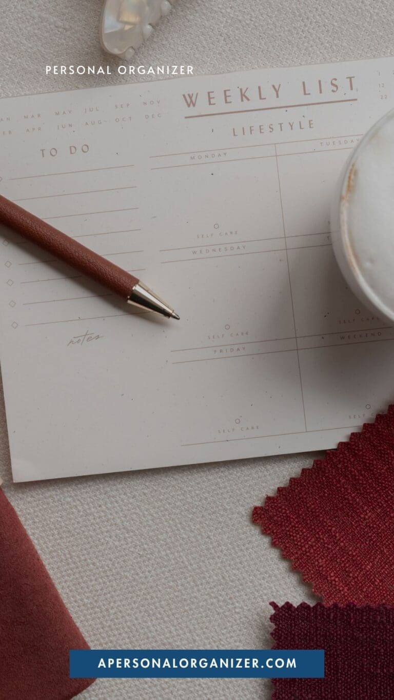A weekly planner page with a pen, a cup, and fabric swatches—perfect for organizing your week. The top reads "Personal Organizer" and the bottom displays "APERSONALORGANIZER.COM" on a blue banner.