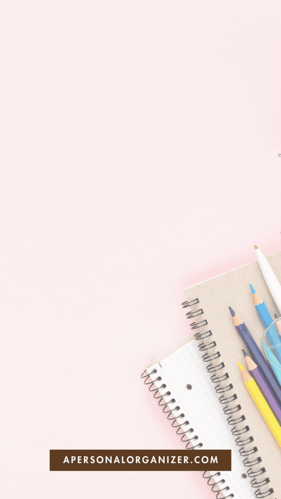 An overhead view of a teal backpack partially open to reveal school supplies including a notebook, a yellow alarm clock, and various stationery items like paper clips and sticky notes, all arranged on a bright yellow background.
