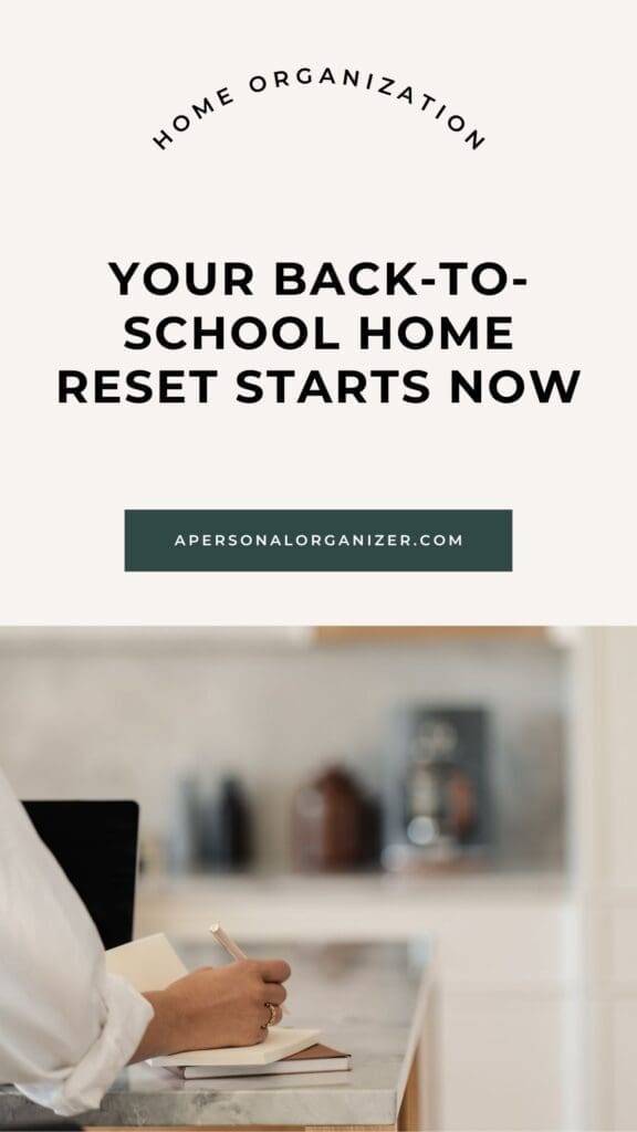 A person writes in a notebook near a laptop in a kitchen. Text reads: "Home Organization. Your back-to-school home reset and school supplies checklist start now. apersonalorganizer.com.