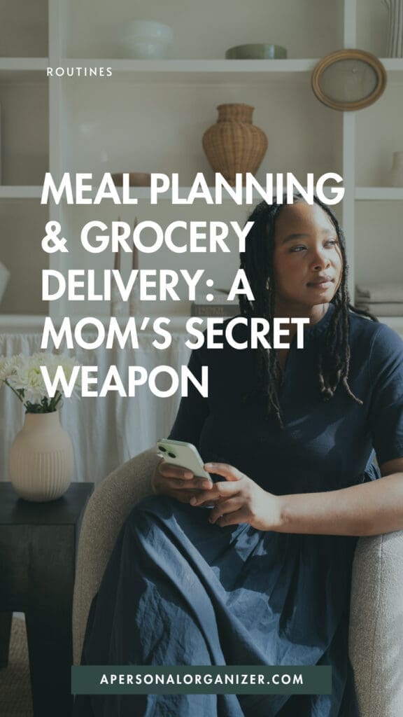 A woman sits in a cozy living room chair holding a smartphone, looking thoughtful. Text on the image reads, “Meal planning & grocery delivery: time saving hacks for moms.” Shelves with home decor are visible in the background.