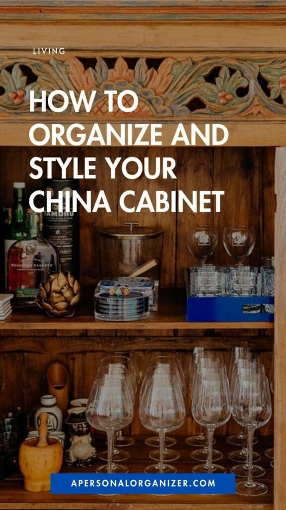 A wooden china cabinet with ornate carvings is filled with glassware, plates, bowls, and bottles. Bold white text over the image reads, "How to Organize and Style Your China Cabinet.