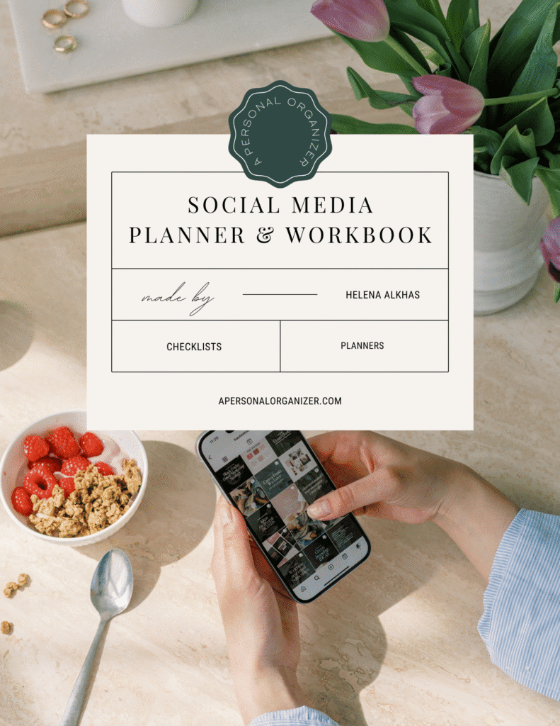 A person holding a smartphone browses Instagram at a tidy table with a bowl of granola and strawberries, a spoon, and a vase with green leaves. Overlaid is a “Social Media Planner & Workbook” cover by Helena Alkhas—perfect for organizing your posts.