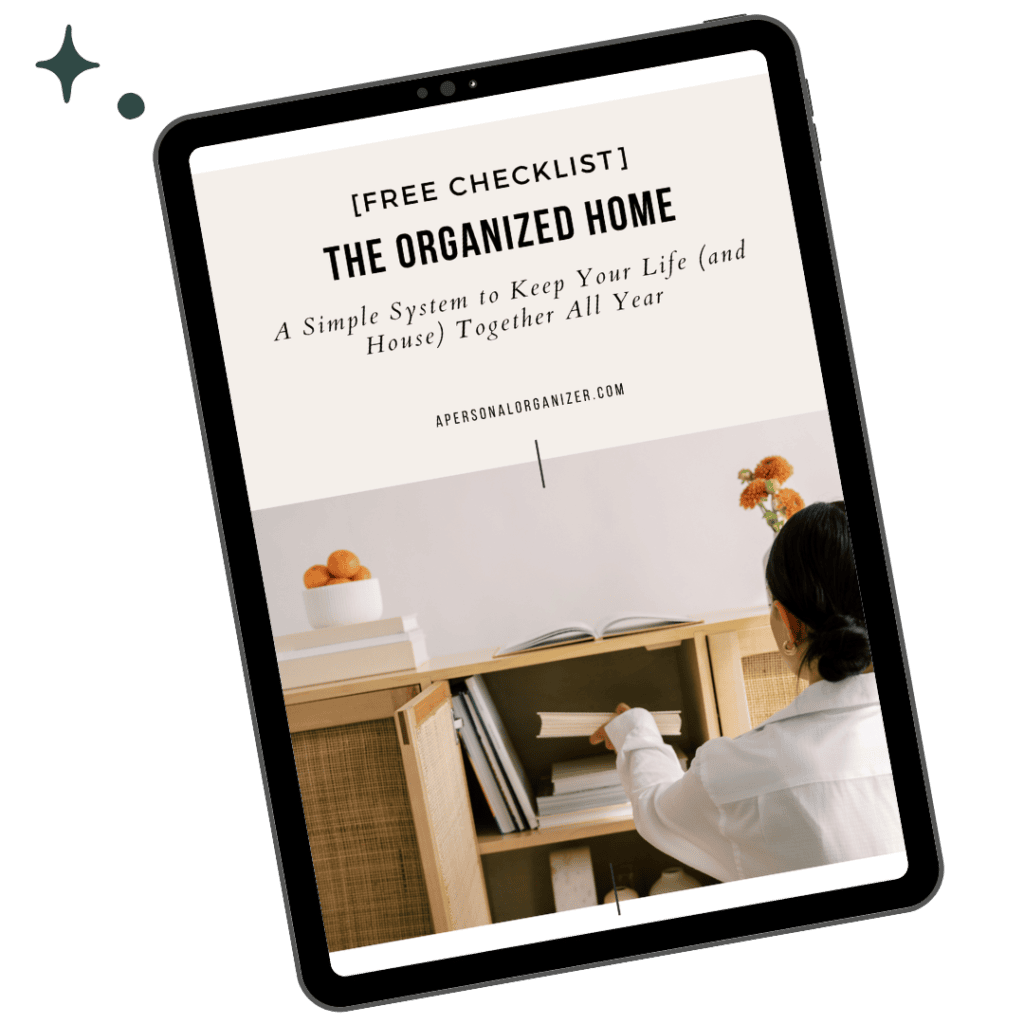 A tablet displays a checklist titled “The Organized Home,” featuring a woman organizing a cabinet in a tidy room with simple decor and fruit bowls.
