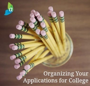 A bundle of yellow pencils with pink erasers stands upright in a glass jar on a wooden surface. The text overlay reads, "Organizing Your College Application," with a small logo featuring blue and green leaves in the upper left corner.