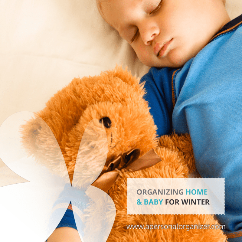 A child sleeps soundly in a cozy nursery, hugging a teddy bear. Text on the image reads "Organizing Home & Baby for Winter" with a website link at the bottom right corner.