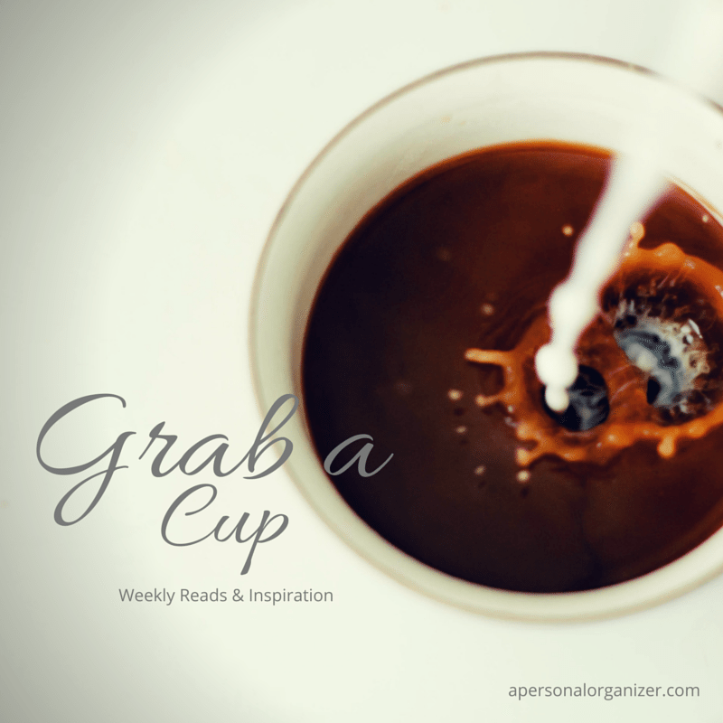 A top-view of a cup filled with coffee being splashed by a pour of cream or milk. The image reads "Grab a Cup - Weekly Reads & Organizing Inspiration" with "apersonalorganizer.com" in smaller print at the bottom right corner.
