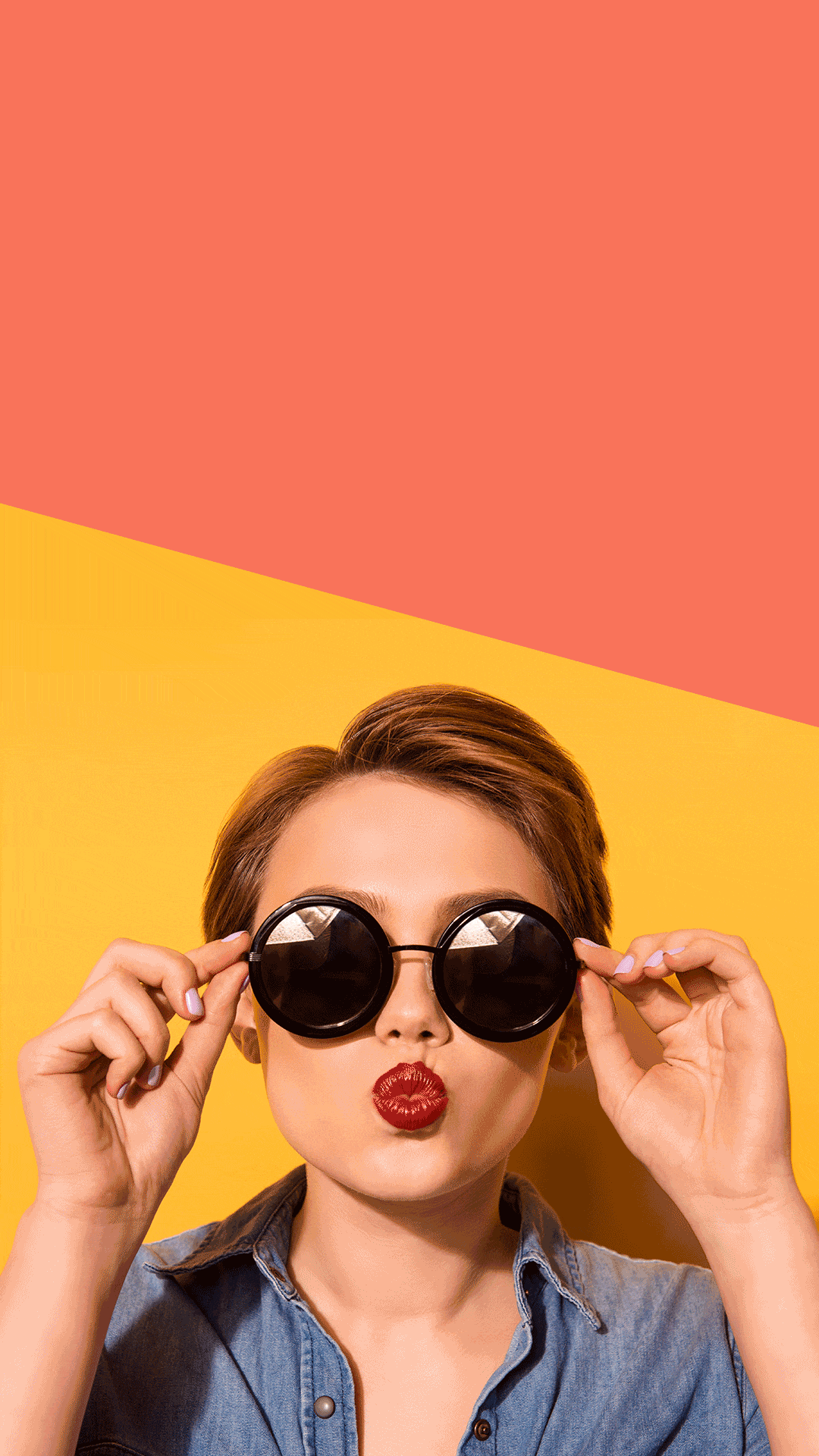 A person with short hair, wearing black sunglasses and a denim shirt, is making a playful expression by puckering their lips. The background consists of two diagonal sections in orange and yellow, perfect for a quirky blog photo.