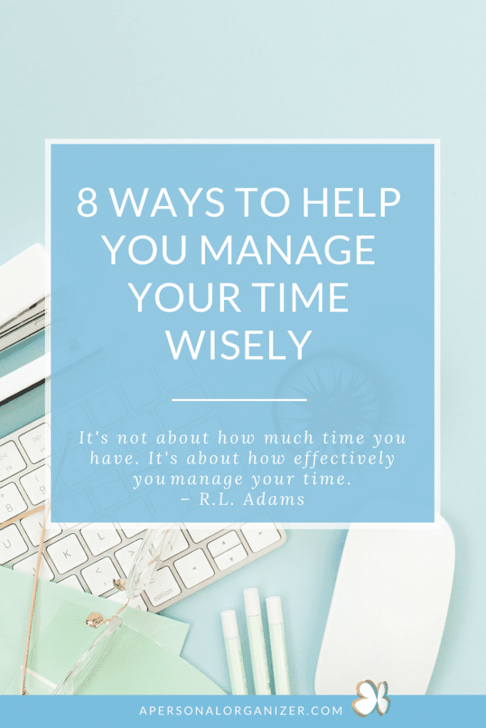 A neatly arranged flat lay includes a white keyboard, notebook, pen, clipboard, glasses, green scissors, and earbuds set against a light blue background. A central text box reads, “8 Ways to Manage Your Time Wisely” with a quote by R.L. Adams below.