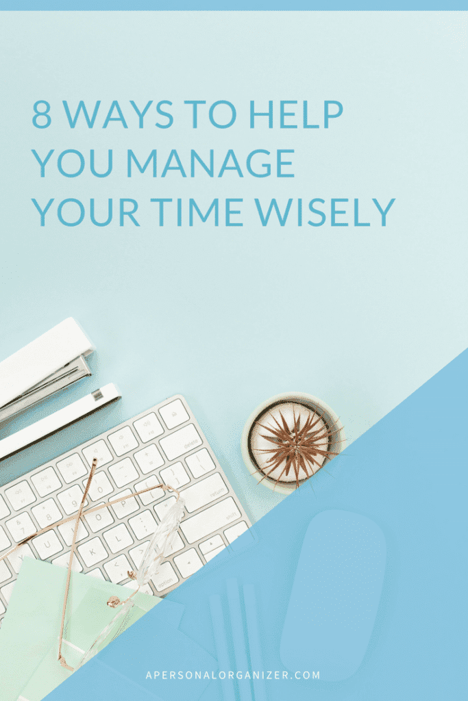 A pastel blue desktop scene with a white keyboard, gold scissors, eyeglasses, and a white stapler. A cactus in a glass pot is placed on the right. Text on the image reads, "8 Ways to Help You Manage Your Time Wisely." The bottom text reads, "apersonalorganizer.com.