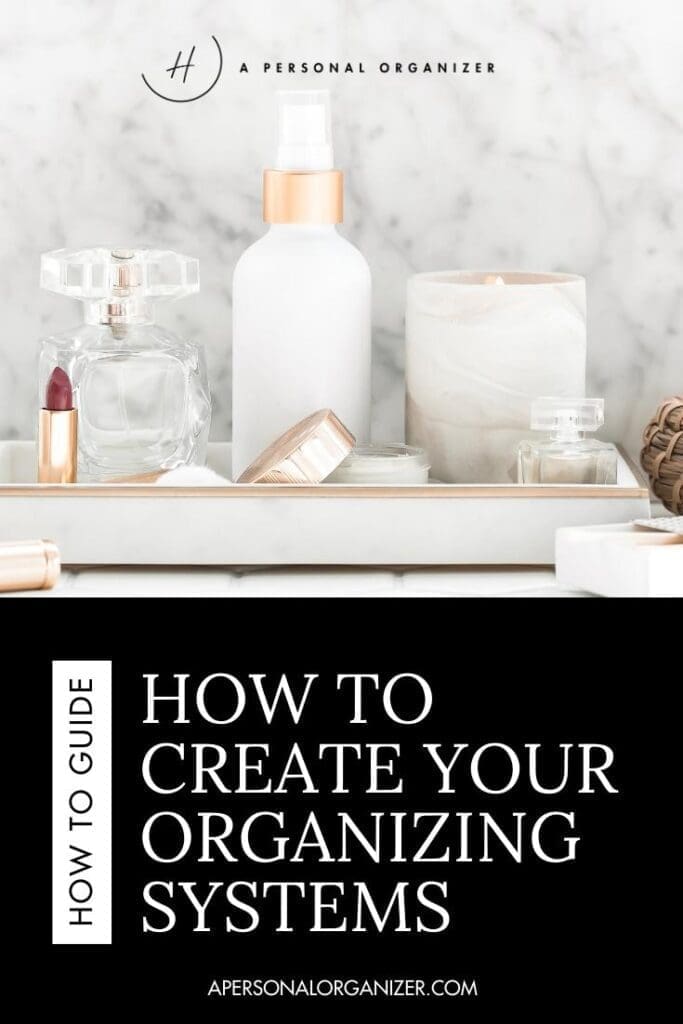 A white tray holds beauty products, including bottles, a candle, and a lipstick, set on a marble surface. Text below reads: "How to Create Your Organizing System. apersonalorganizer.com.