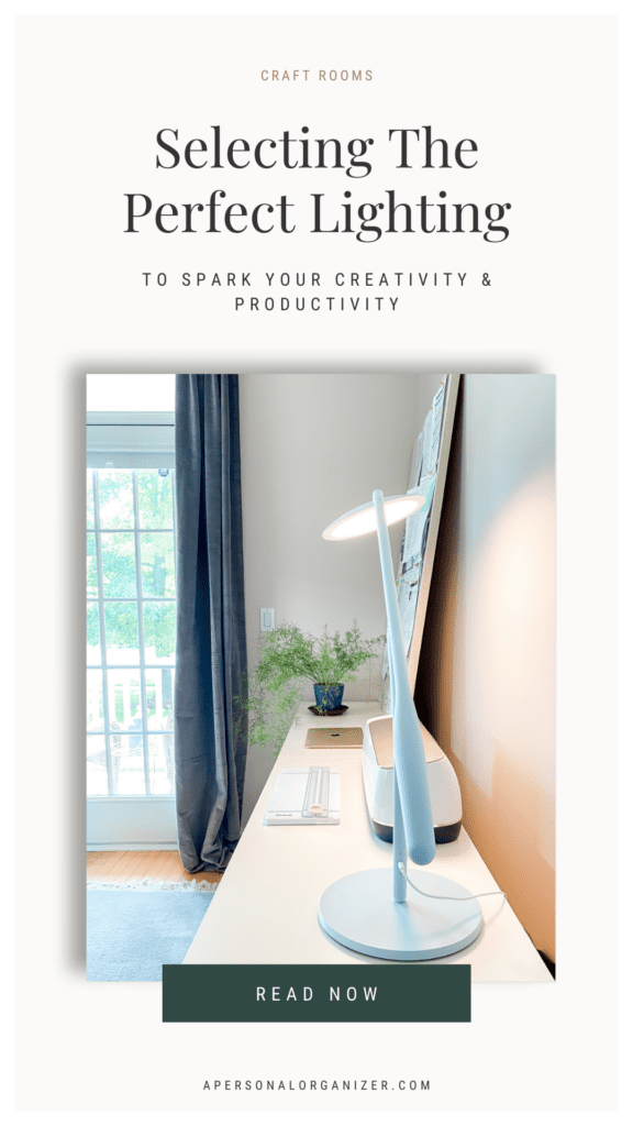 A minimalistic perfect home office setup with a sleek desk lamp on a white desk near large windows with blue curtains. Text reads: "Selecting The Perfect Lighting to Spark Your Creativity & Productivity. Read Now.