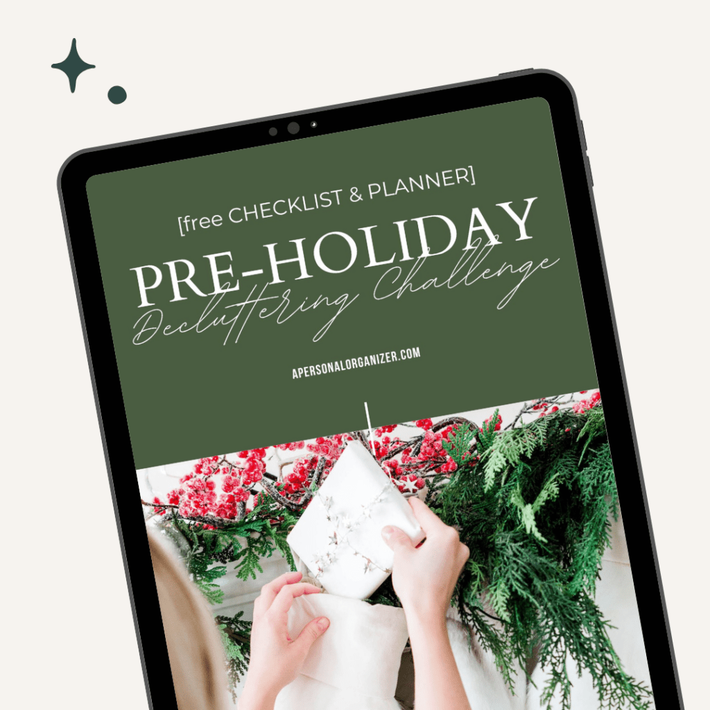 A tablet showcases an "Organizing Pre-Holiday Decluttering Challenge" with a checklist and planner. The screen, set against a green background, features hands wrapping a white gift adorned with evergreen and red berry accents. The website name is elegantly displayed at the bottom.