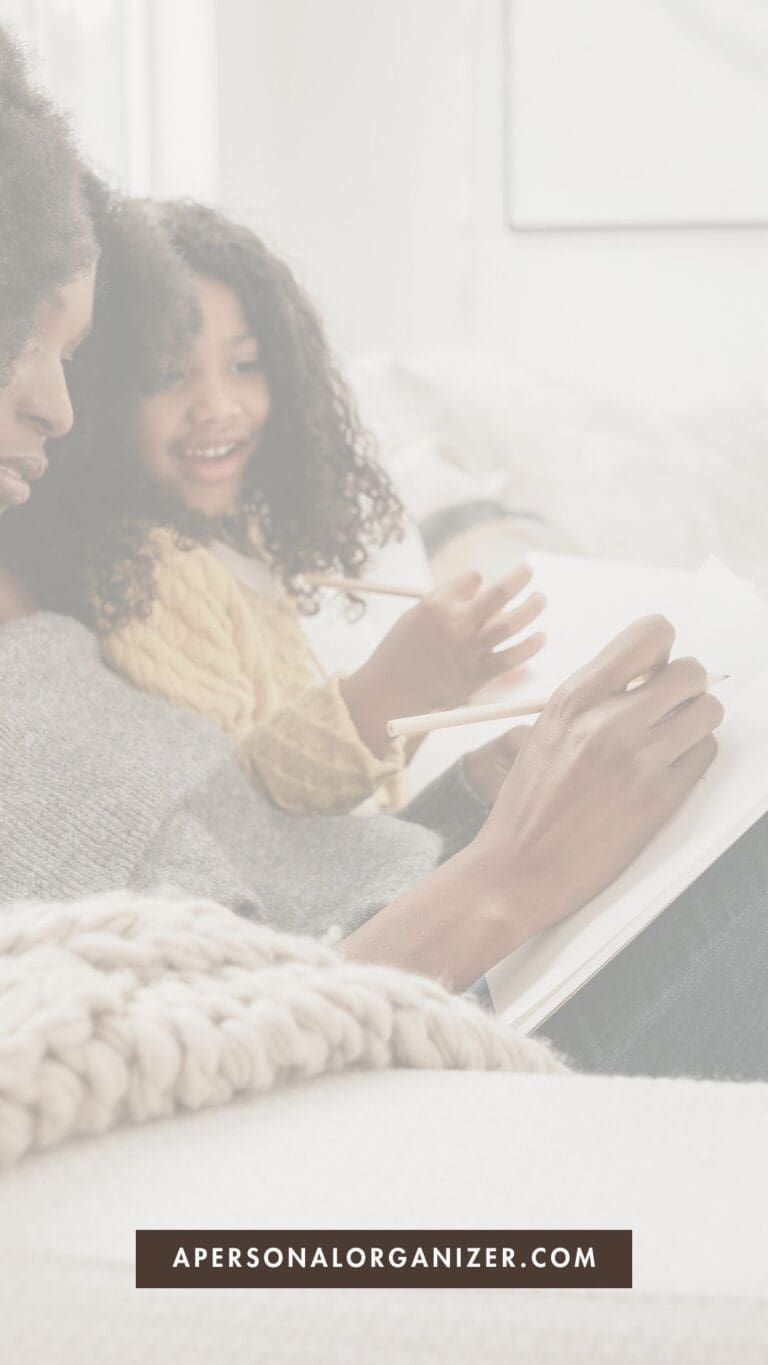A woman and a young girl sit on a couch together, smiling as the woman writes in a notebook—perhaps working on their back to school shopping guide. Text at the bottom reads "apersonalorganizer.com.